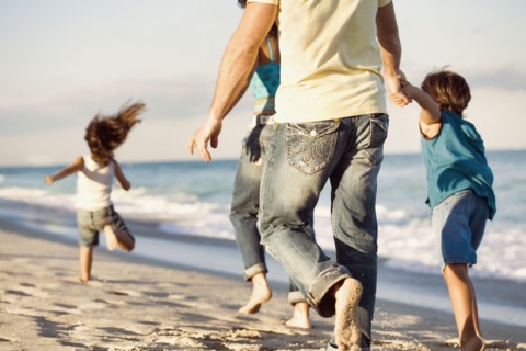 Family running on beach
