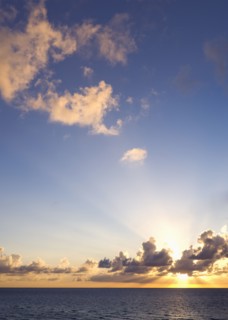 Sun setting over ocean