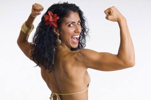 Mixed race woman body builder flexing muscles