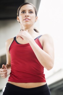 Hispanic woman running in urban area