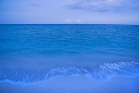 Waves on beach of tranquil blue ocean