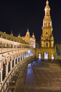 Bell tower and ornate porticoed building at night