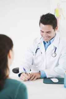 Doctor sitting at desk with patient