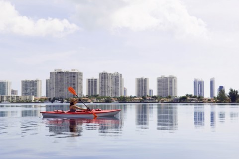 Mixed race woman in kayak on river