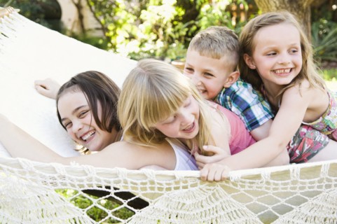 Caucasian children playing in tree