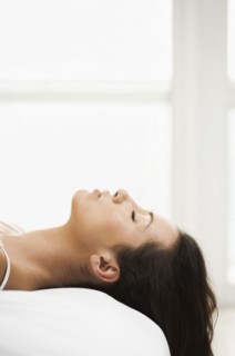 Hispanic woman laying on bed