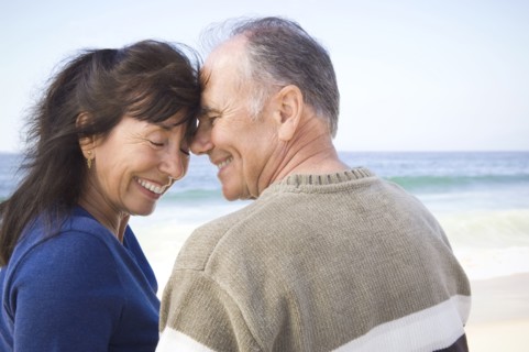 Smiling couple hugging on beach