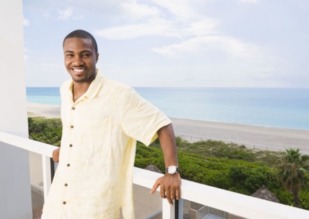 African American man standing on balcony