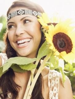 Hispanic woman holding sunflowers