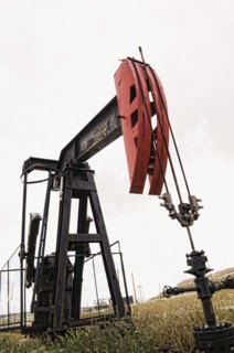 Pump working in oil field in remote landscape