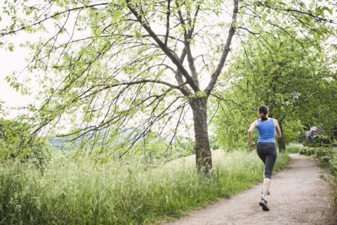 Mixed race woman running on path