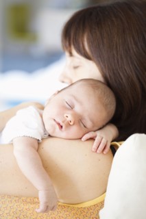 Mother holding sleeping baby