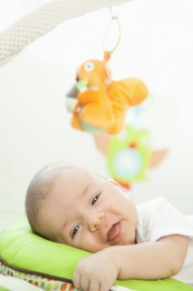 Mixed race  baby laying on pillow