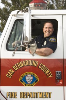 Caucasian firefighter smiling in fire truck