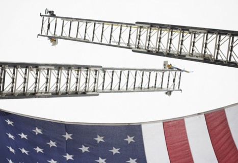 Low angle view of crane ladders and American flag