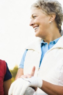 Caucasian woman wearing gloves on golf course
