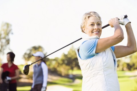 Woman playing golf on golf course