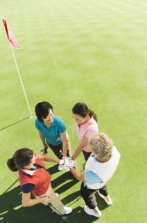 Women celebrating on golf course