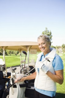 Caucasian woman selecting club on golf course