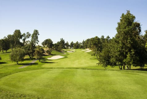 High angle view of golf course under blue sky