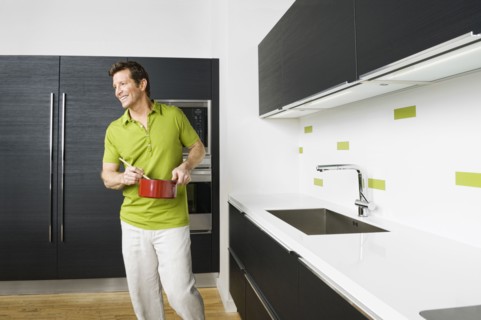Caucasian man cooking in kitchen