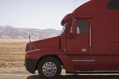 Red semi-truck against mountains