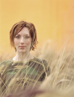Caucasian woman standing in tall grass