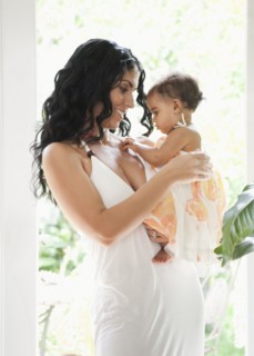 Mixed Race mother holding baby daughter