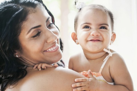 Mixed Race mother holding baby daughter