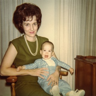 Caucasian mother sitting in chair holding baby son