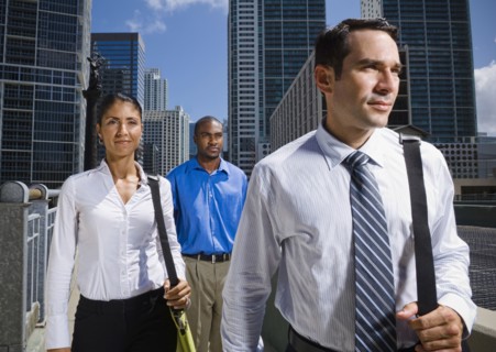 Serious business people walking in city