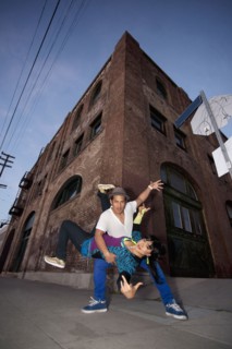 Couple breakdancing in urban area