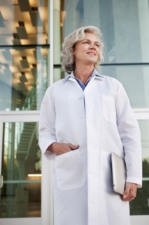 Doctor holding digital tablet outdoors