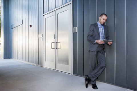 Businessman using digital tablet outdoors
