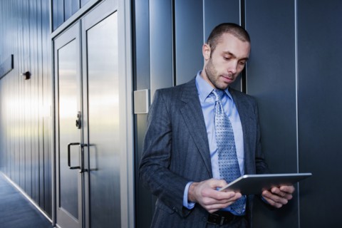 Businessman using digital tablet outdoors