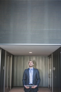 Businessman using digital tablet in corridor