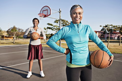 Mother and daughter playing basketball
