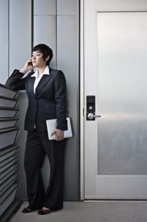 Businesswoman talking on cell phone and holding digital tablet