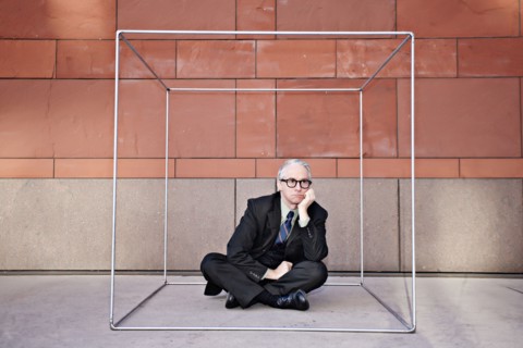 Caucasian businessman sitting inside of box