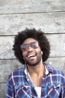 Smiling Black man listening to mp3 player