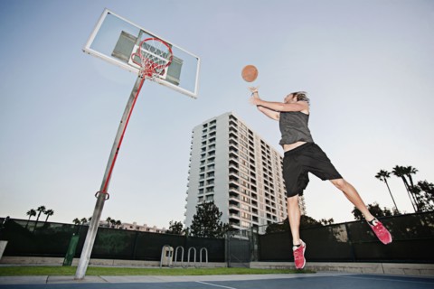 Caucasian man playing basketball outdoors
