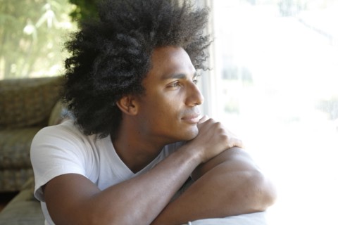 Man sitting on sofa thinking