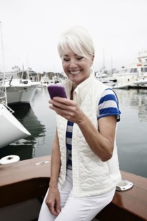Woman using cell phone in marina