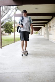 Caucasian teenager riding skateboard
