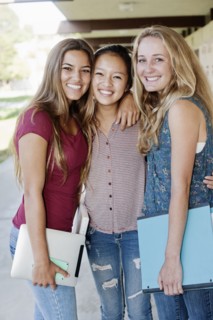 School friends standing in portico
