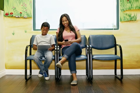 Mixed race boy and mother in waiting room