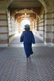Caucasian graduate walking in portico