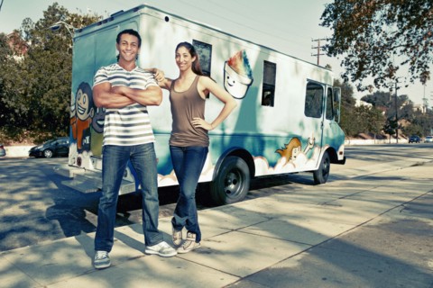 Couple standing by ice cream truck