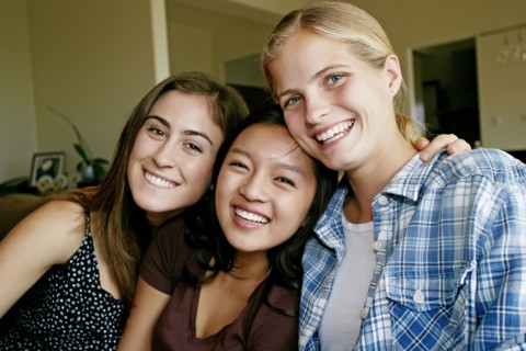 Smiling girls sitting together