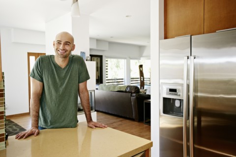 Hispanic man standing in kitchen